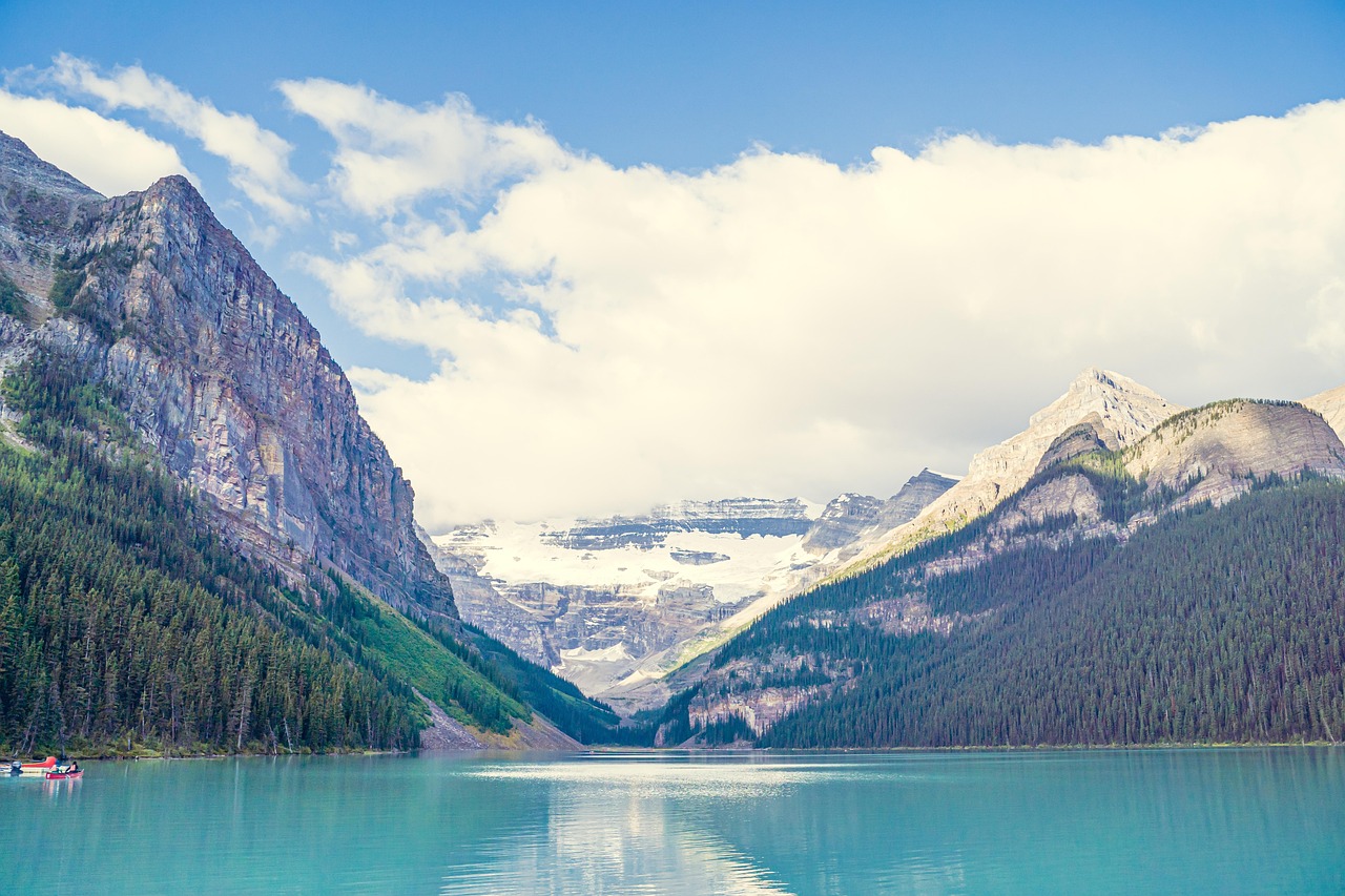 Turquoise waters of Lake Louise surrounded by snow-capped Rocky Mountain peaks