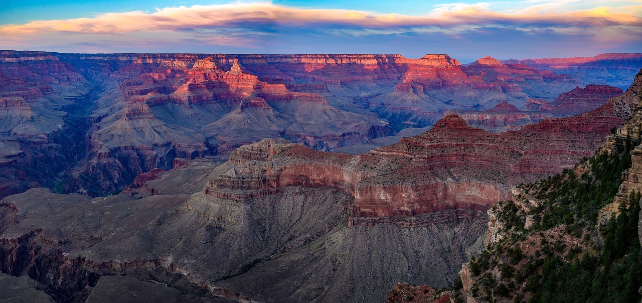 Layered red rock walls of the Grand Canyon glowing at sunset