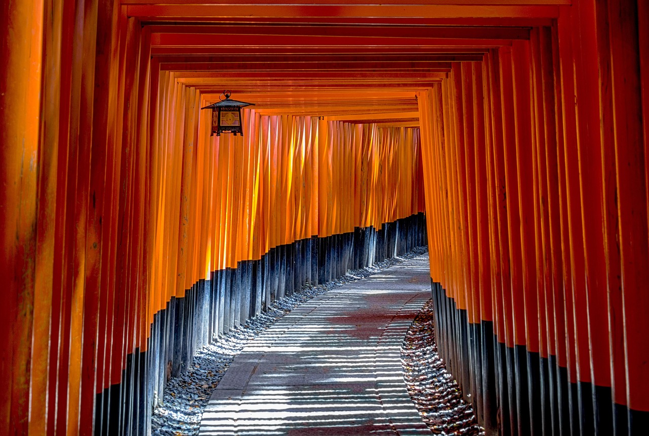 Vermilion torii gates lining a temple path in Kyoto, Japan